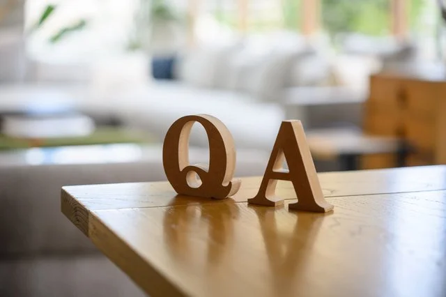 ボケた背景に置かれた木製のQ&Aの文字